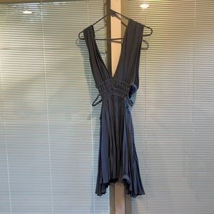 Powder blue dress cut low with cut out sides .